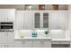 White kitchen featuring plenty of counter space, shaker cabinets, and wine storage at 11271 Winter Cottage Pl, Las Vegas, NV 89135