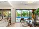Modern living room with a view of the pool, dining area and access to outdoor seating at 11271 Winter Cottage Pl, Las Vegas, NV 89135