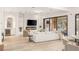 Open-concept living area with modern fireplace, bar, and sliding doors to backyard at 11271 Winter Cottage Pl, Las Vegas, NV 89135
