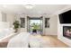 Comfortable main bedroom with a fireplace, balcony access, light floors and contemporary finishes at 11271 Winter Cottage Pl, Las Vegas, NV 89135
