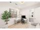 Bright office with white furniture, desk, and plant, adjoining with a bathroom at 11271 Winter Cottage Pl, Las Vegas, NV 89135