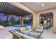 Covered patio boasts ample seating and relaxing views of the pool at 11271 Winter Cottage Pl, Las Vegas, NV 89135