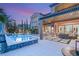 Inviting pool and spa surrounded by lush landscaping and a covered patio at 11271 Winter Cottage Pl, Las Vegas, NV 89135