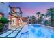 Luxurious backyard features a sparkling pool, spa, covered patio, and lush landscaping at 11271 Winter Cottage Pl, Las Vegas, NV 89135