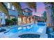 Sparkling pool and lush landscaping highlight this backyard oasis at dusk at 11271 Winter Cottage Pl, Las Vegas, NV 89135
