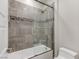 Stylish bathroom featuring shower over tub with gray tiled walls and glass doors at 11280 Granite Ridge Dr # 1009, Las Vegas, NV 89135