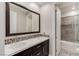 Elegant bathroom featuring double sinks with decorative tile backsplash and a large mirror at 11280 Granite Ridge Dr # 1009, Las Vegas, NV 89135