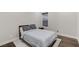 Simple bedroom with wood floors, rug, bed, and bedside table next to a window at 11280 Granite Ridge Dr # 1009, Las Vegas, NV 89135