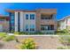 A modern home features a mixed facade of stone and stucco with balconies and a landscaped yard at 11280 Granite Ridge Dr # 1009, Las Vegas, NV 89135