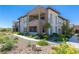 Condominium exterior featuring stone accents, balconies, manicured landscaping and walking paths at 11280 Granite Ridge Dr # 1009, Las Vegas, NV 89135