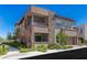 Two-story home with stone accents, a two-car garage, desert landscaping and a second story balcony at 11280 Granite Ridge Dr # 1009, Las Vegas, NV 89135