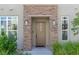 Front door featuring a sidelight and stone pillars with an 'Oh hello' welcome mat at 11280 Granite Ridge Dr # 1009, Las Vegas, NV 89135