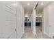 Hallway leading to the modern bathroom with tiled floor and ample lighting at 11280 Granite Ridge Dr # 1009, Las Vegas, NV 89135