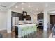 Modern kitchen with stainless steel appliances, a large island, and stylish green chairs at 11280 Granite Ridge Dr # 1009, Las Vegas, NV 89135