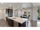 Modern kitchen with stainless steel appliances, island with seating, and dining area at 11280 Granite Ridge Dr # 1009, Las Vegas, NV 89135