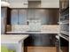 Modern kitchen with stainless steel appliances and mosaic backsplash at 11280 Granite Ridge Dr # 1009, Las Vegas, NV 89135