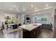 Bright, open-concept kitchen with island, stainless steel appliances, hardwood floors, and dining area at 11280 Granite Ridge Dr # 1009, Las Vegas, NV 89135
