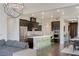 A modern kitchen featuring stainless steel appliances, dark cabinetry, and a kitchen island with seating at 11280 Granite Ridge Dr # 1009, Las Vegas, NV 89135