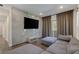 Cozy living room featuring a large flat screen TV, comfortable sofa, and hardwood floors at 11280 Granite Ridge Dr # 1009, Las Vegas, NV 89135