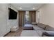 Comfortable living room with large sectional sofa and a mounted flat screen TV at 11280 Granite Ridge Dr # 1009, Las Vegas, NV 89135