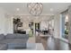 Open concept living room featuring a modern chandelier and hardwood floors at 11280 Granite Ridge Dr # 1009, Las Vegas, NV 89135
