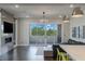 A spacious living room featuring a sleek fireplace, hardwood floors and a modern chandelier at 11280 Granite Ridge Dr # 1009, Las Vegas, NV 89135