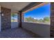 Covered outdoor patio featuring stone pillars, brick flooring, and a view of the desert landscape at 11280 Granite Ridge Dr # 1009, Las Vegas, NV 89135