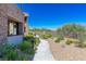 A stone walkway leads to the home, bordered by manicured landscaping and a wrought iron fence at 11280 Granite Ridge Dr # 1009, Las Vegas, NV 89135