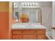 Bathroom features a wood vanity with white countertop, framed mirrors, and a shower/tub combo at 1230 Pagentry Dr, North Las Vegas, NV 89031