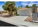 Charming one-story home with a well-maintained yard, desert landscaping, and attached two-car garage at 1230 Pagentry Dr, North Las Vegas, NV 89031