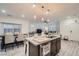 Stylish kitchen with granite countertops, stainless steel sink, and open design flowing into the living and dining areas at 1328 Graphite Ave, Henderson, NV 89002