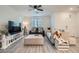 Bright living room with a blend of sofas, white furnishings, and large screen TV for cozy relaxation at 1328 Graphite Ave, Henderson, NV 89002