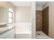 Bathroom featuring soaking tub and tiled shower at 1345 Stokes St, Las Vegas, NV 89110