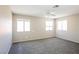 Spacious bedroom with neutral carpet and three windows at 1345 Stokes St, Las Vegas, NV 89110