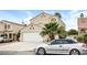 Charming two-story home with a well-manicured lawn, a two-car garage and a driveway at 1345 Stokes St, Las Vegas, NV 89110