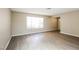 Inviting living room with wood flooring, a large window, and ample natural light at 1345 Stokes St, Las Vegas, NV 89110