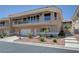 Exterior elevation featuring a balcony and garage with desert landscaping at 144 Desert Valley Dr, Boulder City, NV 89005