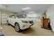 Spacious garage featuring a white car, ample storage cabinets, and a laundry area at 144 Desert Valley Dr, Boulder City, NV 89005