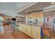 Spacious kitchen features stainless steel appliances and a center island with bar seating and lovely wood floors at 144 Desert Valley Dr, Boulder City, NV 89005