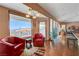 Bright living room boasts large windows with amazing views, wood floors, and comfortable seating areas at 144 Desert Valley Dr, Boulder City, NV 89005