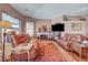 Inviting living room with a fireplace, plush sofas, and a decorative rug over hardwood floors at 144 Desert Valley Dr, Boulder City, NV 89005