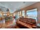 Bright living room with hardwood floors, leather sofas, and sliding doors leading to the balcony at 144 Desert Valley Dr, Boulder City, NV 89005