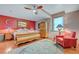 Cozy bedroom with a wooden bed frame, soft lighting, and a comfortable sitting area at 144 Desert Valley Dr, Boulder City, NV 89005