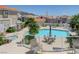 Community pool and spa area surrounded by palm trees and lounge chairs, perfect for relaxation at 144 Desert Valley Dr, Boulder City, NV 89005