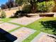 Well-maintained backyard with a brick patio and manicured lawn, perfect for entertaining guests at 147 Augusta Course Ave, Las Vegas, NV 89148
