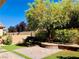 Lush backyard featuring brick pavers, green grass, and mature trees, ideal for outdoor enjoyment at 147 Augusta Course Ave, Las Vegas, NV 89148