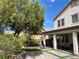 Spacious backyard oasis featuring a covered patio, artificial grass, paved area, and mature landscaping at 147 Augusta Course Ave, Las Vegas, NV 89148