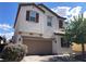 Charming two-story home featuring a neutral stucco facade, brick driveway, and well-maintained landscaping at 147 Augusta Course Ave, Las Vegas, NV 89148