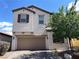 Charming two-story home featuring a neutral stucco facade, brick driveway, and well-maintained landscaping at 147 Augusta Course Ave, Las Vegas, NV 89148