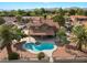 An aerial view of a home showing a kidney-shaped pool, covered patio, and desert landscaping at 1587 Bermuda Dunes Dr, Boulder City, NV 89005